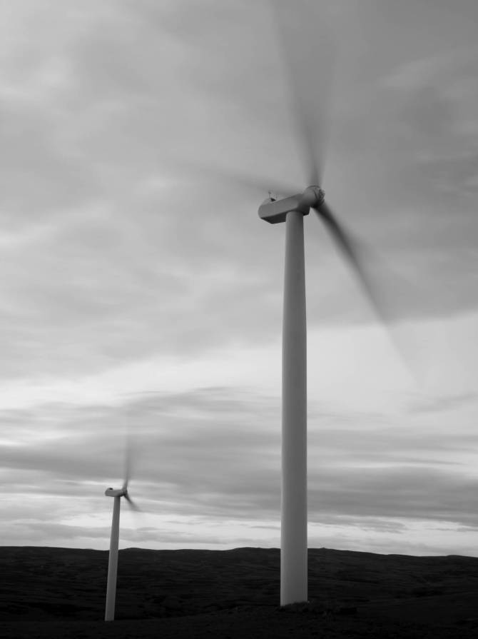 Two wind turbines at sunset.